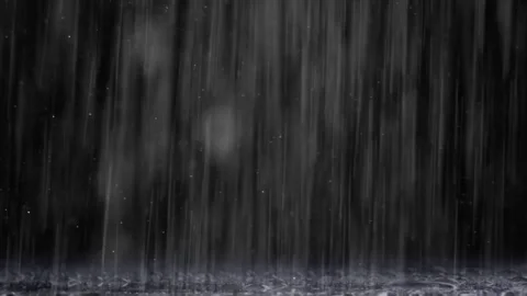 Heavy rainfall pouring down onto dark wet surface with striking textured ground 库存影片 340941564
