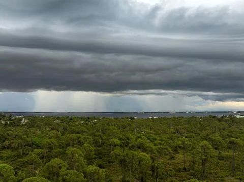 Heavy rainfall pouring down from storm clouds above Charlotte Harbor in Flo.. Photos