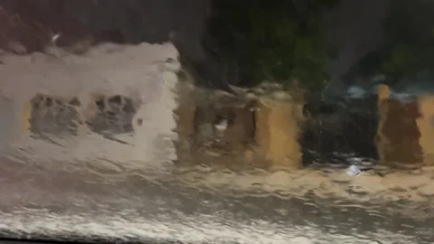 Heavy rainfall seen from inside a parked car.Dramatic weather atmosphere concept Stock Footage 328942933