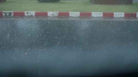 Heavy raining on the road from vehicle window scene with passing car Stock Footage 119760484