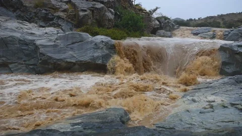 Heavy rains on the top of the green mountain led to the flow of the Nizwa Stock Footage 106923361