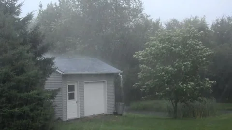Heavy Rainstorm Pouring Down on Residential Property Stock Footage 346161342