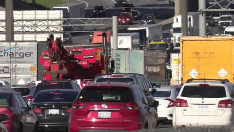Heavy rush hour traffic jam and gridlock on highway 401 in Toronto Stock Footage 153697576