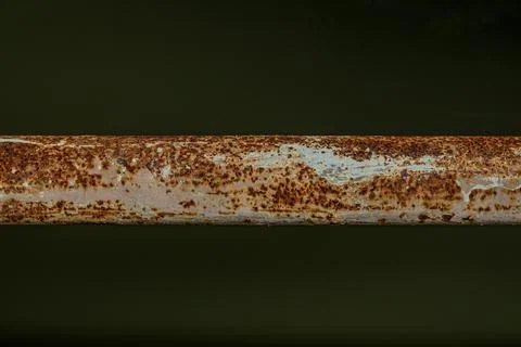 Heavy rust texture on horizontal iron pipe near midnight  Stock Photos