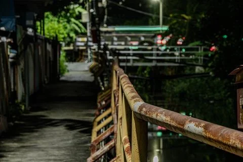 Heavy rust texture on industrial iron railing along suburban canal walkwa Stock Photos