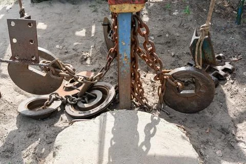 Heavy rusty weights and chains on brutal outdoor gym equipment. Stock Photos