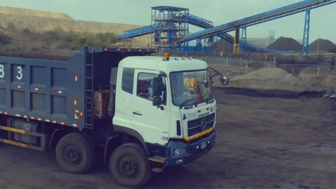 Heavy SECMC Dump Truck Driving Past Conveyor Structure 스톡 동영상 345021662