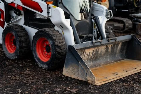 Heavy skid steer loader with large front bucket used in construction Stock Photos