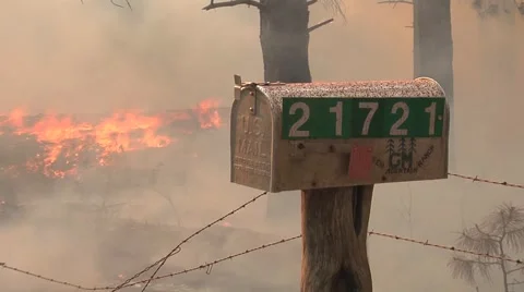 Heavy smoke and fire surround mail box on mountain road Video stock 40954273