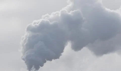Heavy smoke causing air pollution on gray sky background Stock Photos