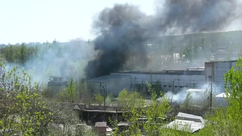 Heavy smoke from a large fire over an industrial building Stock Footage 346742541