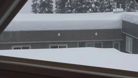 Heavy Snow Accumulation on Roof Viewed from Window Stock Footage 263185053