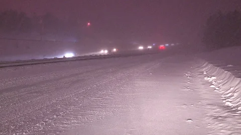 Heavy snow and blowing snow on highway at night v9 Stock Footage 36641433