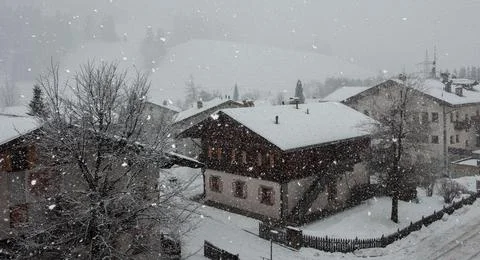 Heavy snow between Tyrolean huts in the mountains Stock Photos