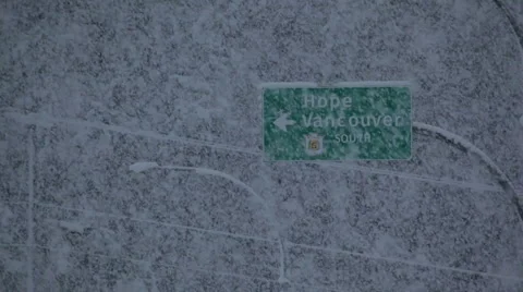 Heavy snow falling in front of traffic sign Stock Footage 1085085