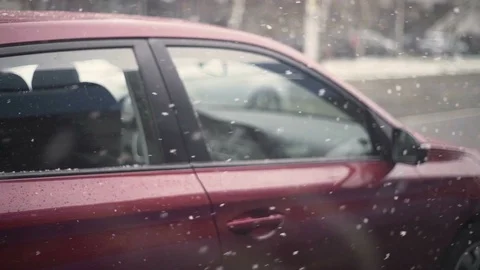 Heavy snow falling over red car during the day, Croatia. Stock Footage 114691229
