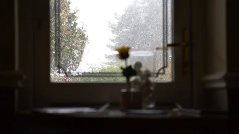 Heavy snow falling past a set dinner table in restaurant, 4k, UHD Stock Footage 86470422