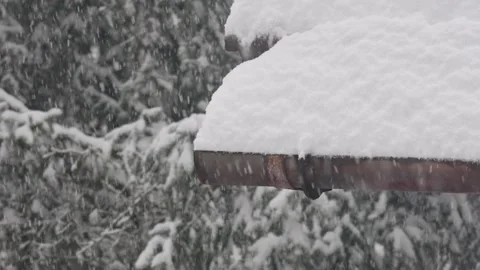 Heavy snow falling on roof gutter Stock Footage 330062888