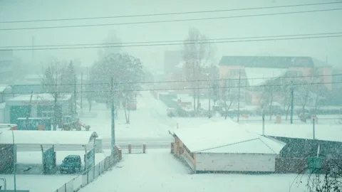 Heavy snow falling in winter on a road of small town Stock Footage 71121201
