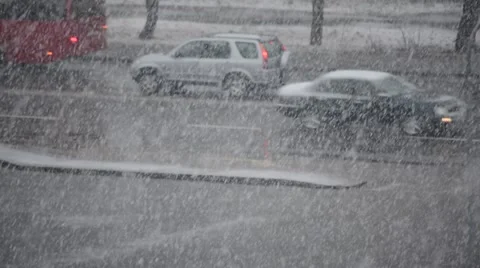 Heavy snow falls on background of road with cars driving Stock Footage 67436506