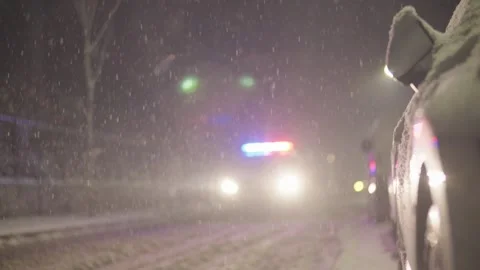 Heavy Snow Falls at Night on Empty Street with Parked Car Video stock 339067140