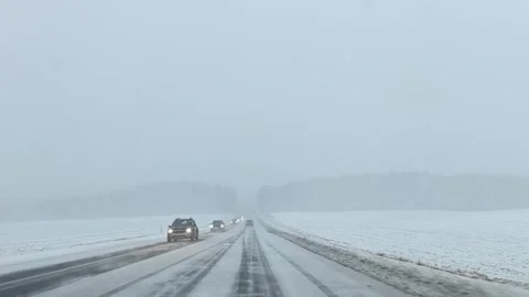 Heavy snow makes driving difficult on rural road in winter afternoon Stock Footage 326376289