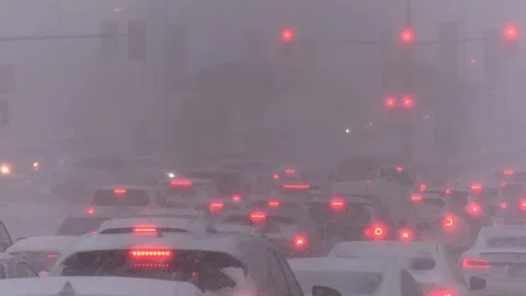 Heavy snow in winter storm causing traffic gridlock in the city streets Stock Footage 125648397