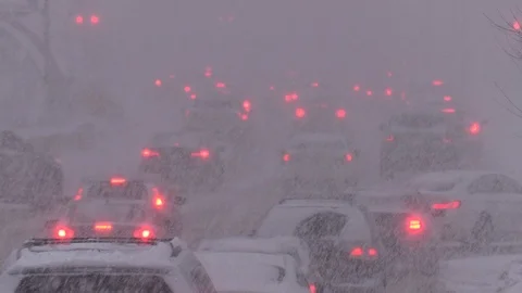Heavy snow in winter storm causing traffic gridlock in the city streets Stock Footage 125649575