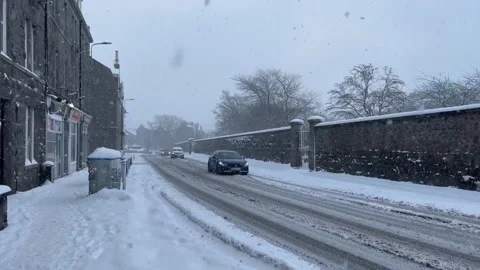 Heavy snowfall in Aberdeen creates hazardous conditions for drivers Stock Footage 325657084