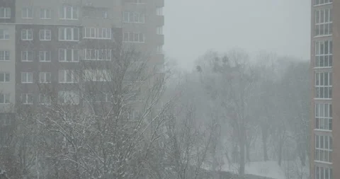 Heavy snowfall and poor visibility in the city Stock Footage 164642117