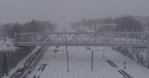Heavy snowfall and wind around the railroad tracks in Helsinki Stockbeeldmateriaal 86329709