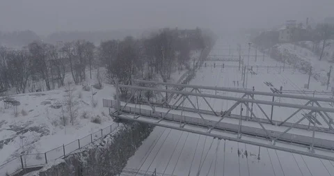 Heavy snowfall and wind around the railroad tracks in Helsinki Stock Footage 86330544