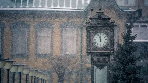 Heavy snowfall in the city.The town clock covered with snow. Stock Footage 69963610