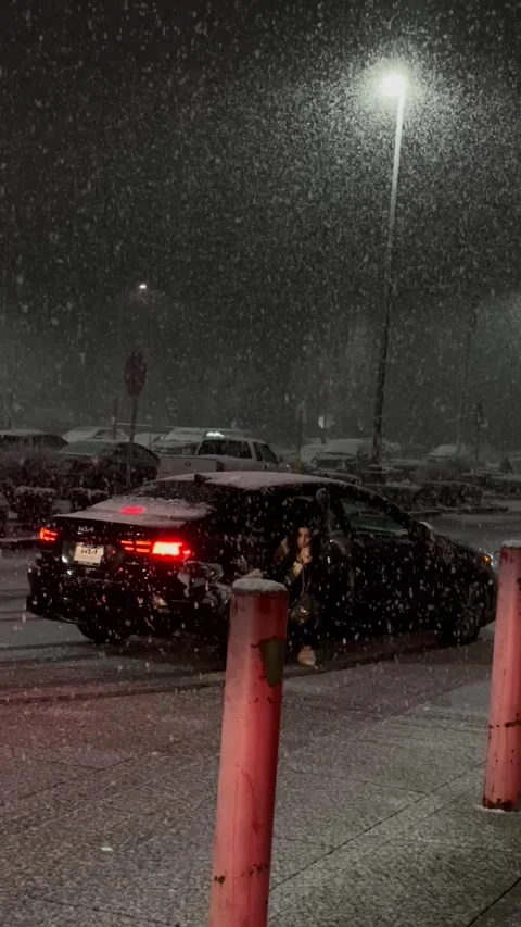 Heavy snowfall in the evening in winter the car drives up Stock Footage 241029608