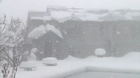 Heavy snowfall in front of already snow covered building 스톡 동영상 10787934