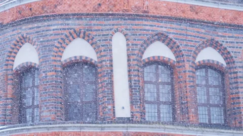 Heavy snowfall, Holsten Gate or Holstentor in Lubeck Stock Footage 96184181