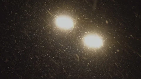 Heavy snowfall in the light of a street lamp Stock Footage 101681444
