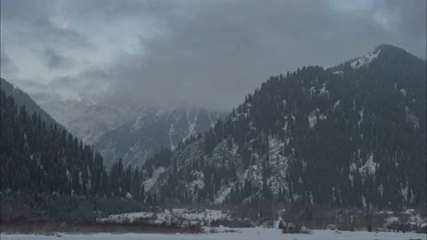 Heavy snowfall in the mountains ends and majestic mountain peaks appear Stock Footage 143923865