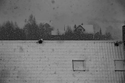 Heavy snowfall over rooftops and houses Stock Photos