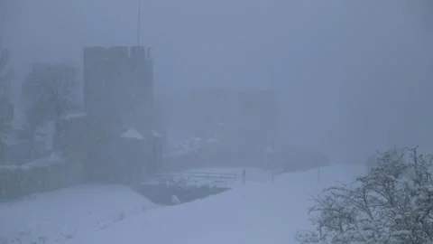 Heavy snowfall over Visby's historic city wall, Ringmuren, in winter, Visby Stock Footage 328587228