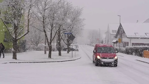 Heavy Snowfall, Red Car Moving towards the Camera, Headlights On , Slow Motion Stock Footage 85226044