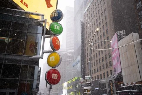 Heavy snowfall in Times Square with M and M's signs Stock Photos