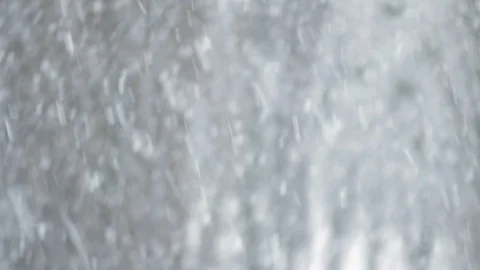 Heavy snowfall with trees blurred in background pan left to right Stock Footage 124215740