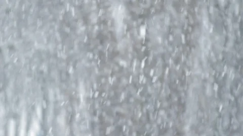 Heavy snowfall with trees blurred in background. Snow falling close up Stock Footage 125037053