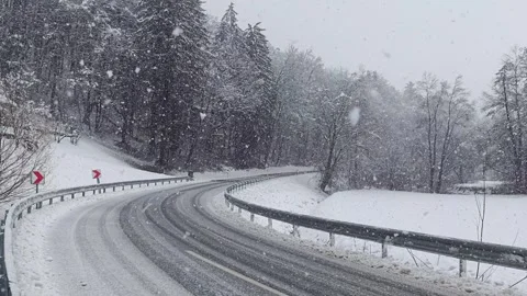 Heavy Snowfall on Winding Road Stock Footage 329616786