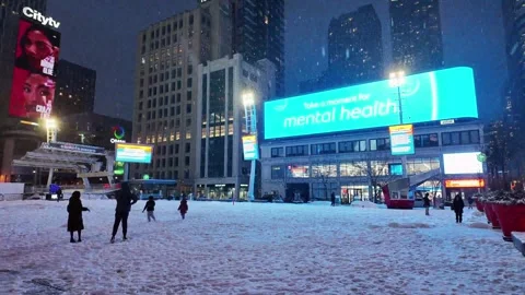 Heavy snowfall at Yonge-Dundas Square in Toronto at night Stock Footage 327992748