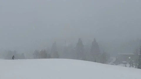 Heavy Snowstorm Blankets a Wide Open Ski Resort Slope on a Dramatic Winter Day Stock Footage 333851829