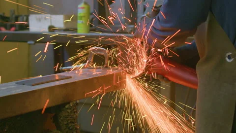 Heavy sparks angle grinder blacksmith metal handheld close up shot Stock Footage 341339990