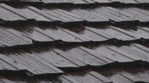 Heavy spring rainfall on tile roof Stock Footage 307429424