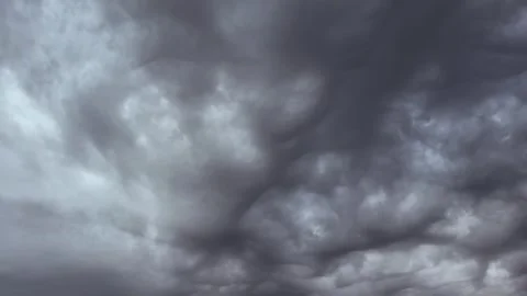Heavy storm clouds of dark gray color cover the sky, heralding heavy rain or Stock Footage 330668535